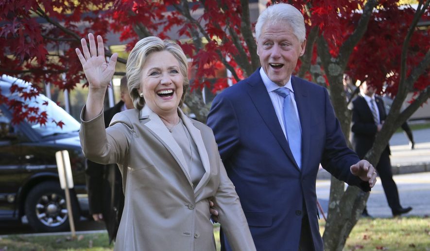 In this Nov. 8, 2016, file photo, Democratic presidential candidate Hillary Clinton, and her husband former President Bill Clinton, greet supporters after voting in Chappaqua, N.Y. The Clintons announced Monday, Oct. 8, 2018, they will visit four cities in 2018 and nine in 2019 across North America in a series of conversations dubbed “An Evening with President Bill Clinton and former Secretary of State Hillary Rodham Clinton.&quot; (AP Photo/Seth Wenig, File)