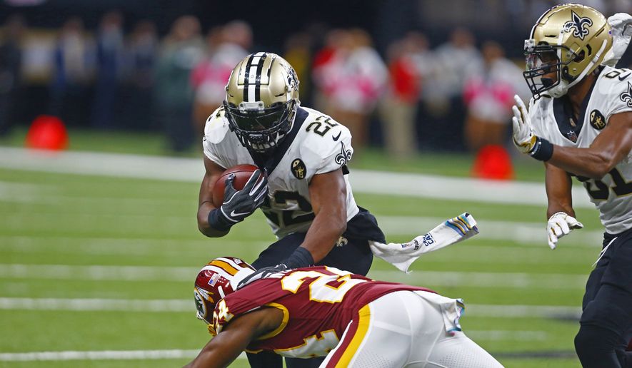 New Orleans Saints running back Mark Ingram (22) carries against Washington Redskins cornerback Josh Norman (24) in the first half of an NFL football game in New Orleans, Monday, Oct. 8, 2018. (AP Photo/Butch Dill)