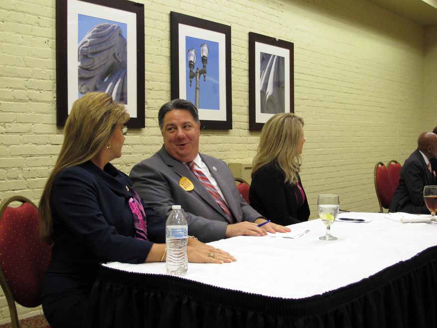 Interim Secretary of State Kyle Ardoin, center, a Baton Rouge Republican, speaks with Renee ...