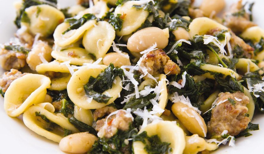 This undated photo provided by America's Test Kitchen in September 2018 shows pasta with sausage, kale and white beans in Brookline, Mass. This recipe appears in the cookbook “One-Pan Wonders.” (Joe Keller/America's Test Kitchen via AP)
