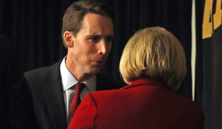 Republican U.S. Senate candidate Josh Hawley, left, talks with incumbent Democratic Sen. Claire McCaskill of Missouri at the end of a candidate forum at the annual Missouri Press Association convention Friday, Sept. 14, 2018, in Maryland Heights, Mo. (AP Photo/Jeff Roberson)