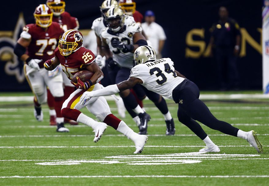 Washington Redskins running back Chris Thompson (25) carries against New Orleans Saints defensive back Justin Hardee (34) in the second half of an NFL football game in New Orleans, Monday, Oct. 8, 2018. (AP Photo/Butch Dill)
