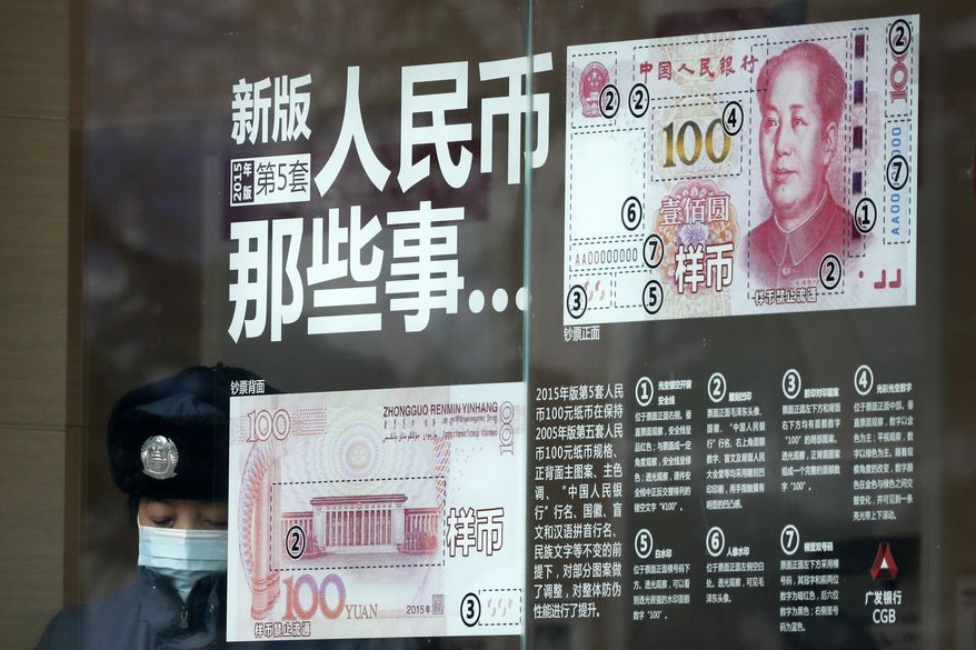 FILE - In this file photo taken Sunday, Jan. 1, 2017, a security guard wearing a protection mask against air pollution takes a rest near a bank window panel displaying the security markers on the latest Yuan note in Beijing. China's government on Tuesday, Oct. 9, 2018 promised not to weaken its currency to boost exports and rejected U.S. concern about the sagging yuan as groundless and irresponsible. (AP Photo/Andy Wong, File)