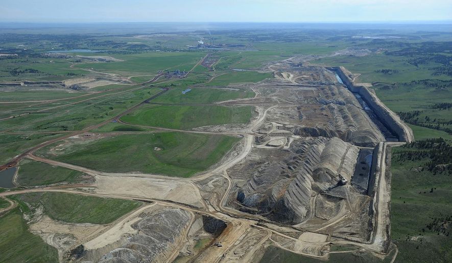 FILE - This file photo taken May 25, 2013, shows an aerial view of Colstrip power plants 1,2,3 & 4 and the Westmoreland coal mines near Colstrip, Mont. Westmoreland Coal Co. of Englewood, Colo., filed for bankruptcy Tuesday, Oct. 9, 2018, to deal with steep debt and declining world demand. Company officials say the Chapter 11 filing is part of a restructuring agreement with an unnamed group of lenders. Company officials say operations won't be interrupted and there are no expected staff reductions. Westmoreland has coal mines in Montana, Wyoming, New Mexico, Ohio, North Dakota and Texas and a coal-fired power plant in North Carolina. (Larry Mayer/The Billings Gazette via AP, File)