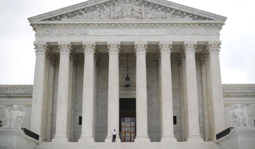 Police office guards the main entrance to the Supreme Court in Washington, Tuesday, Oct. 9, 2018. A Supreme Court with a new conservative majority takes the bench as Brett Kavanaugh, narrowly confirmed after a bitter Senate battle, joins his new colleagues to hear his first arguments as a justice. (AP Photo/Pablo Martinez Monsivais)