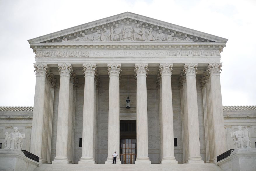 Police office guards the main entrance to the Supreme Court in Washington, Tuesday, Oct. 9, 2018. A Supreme Court with a new conservative majority takes the bench as Brett Kavanaugh, narrowly confirmed after a bitter Senate battle, joins his new colleagues to hear his first arguments as a justice. (AP Photo/Pablo Martinez Monsivais)