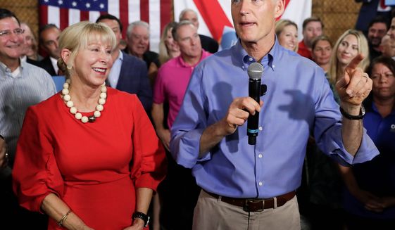 &quot;My wife runs her own finances — that may be a hard thing for Sen. [Bill] Nelson to understand,&quot; said Gov. Rick Scott in a statement. His finances have been scrutinized, particularly regarding his blind trust and wife Ann Scott&#39;s mirrored investments.
FILE — In this Monday, April 9, 2018, file photo, Florida Gov. Rick Scott, with his wife, Ann, announces his bid to run for the U.S. Senate at a news conference, in Orlando, Fla. Multimillionaire Scott maintains that he does not have any say over his fortune, but questions are mounting over his finances. (AP Photo/John Raoux, File) (Associated Press)