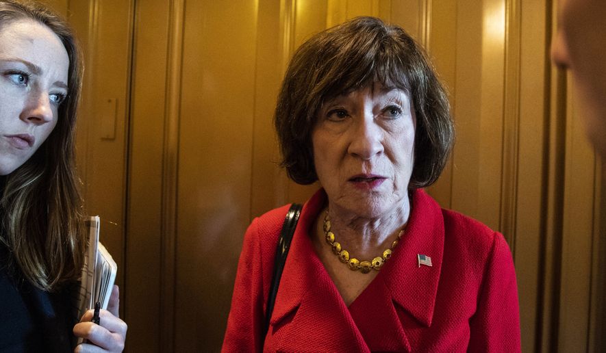 Sen. Susan Collins, R-Maine, right, talks with a reporter on Capitol Hill, Wednesday, Oct. 10, 2018 in Washington. (AP Photo/Alex Brandon)