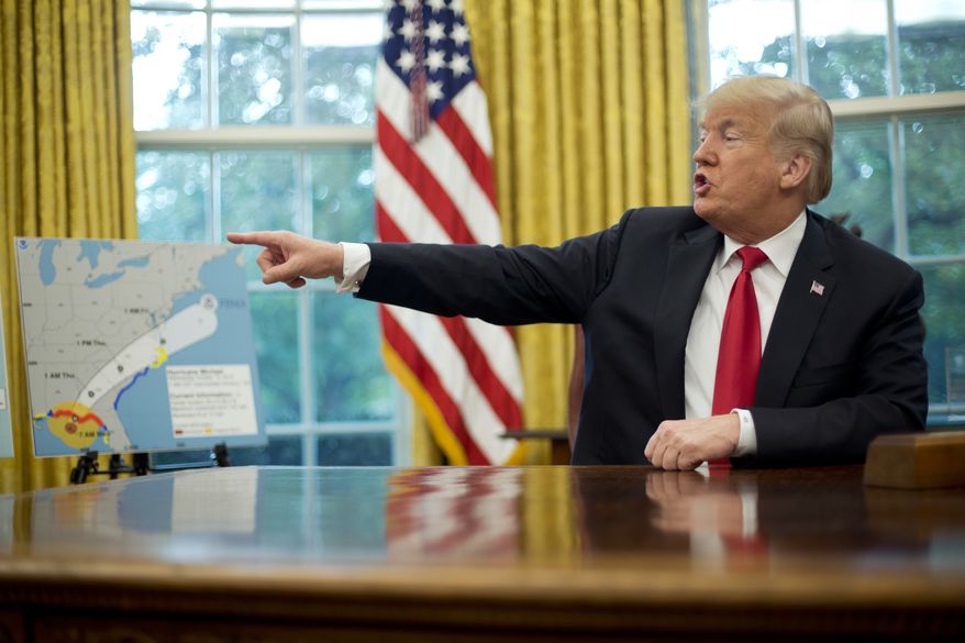 President Donald Trump points towards a map during his meeting to discuss potential damage from Hurricane Michael, in the Oval Office of the White House in Washington, Wednesday, Oct. 10, 2018. (AP Photo/Pablo Martinez Monsivais)