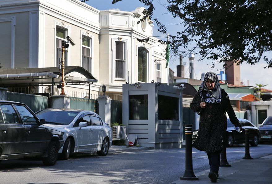 A woman walks past Saudi Arabia's consul's residence, in Istanbul, Wednesday, Oct. 10, 2018. A Turkish television station has aired surveillance video of missing writer Jamal Khashoggi walking into the Saudi Consulate in Istanbul and a black van leaving later for the consul's home. (AP Photo/Lefteris Pitarakis)