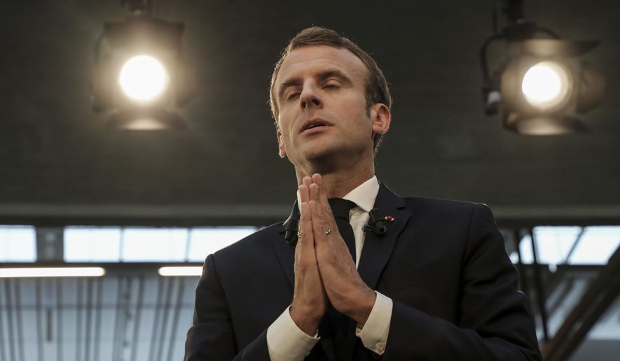 French President Emmanuel Macron addresses the audience as he visits the Station F startup campus in Paris, France, Tuesday, Oct. 9, 2018. (Ludovic Marin/Pool Photo via AP)