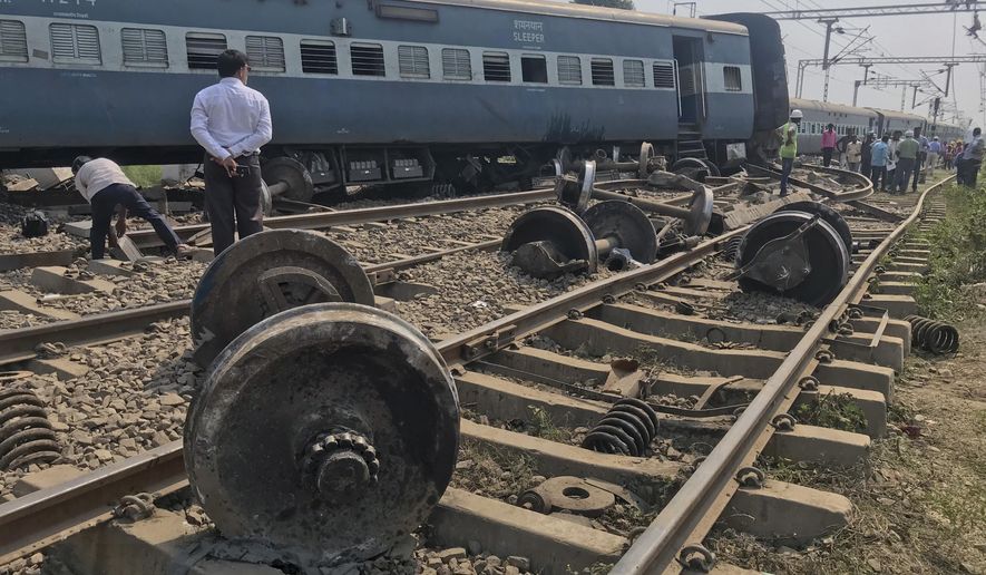 An official stands at the scene after an express train partially derailed at a railway station in Rae Bareli, 80 kilometers southwest of Lucknow, the capital of Uttar Pradesh state, India, Wednesday, Oct.10, 2018. At least 35 passengers were injured and taken to hospitals. (AP Photo)