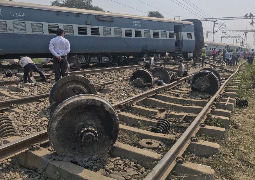 An official stands at the scene after an express train partially derailed at a railway station in Rae Bareli, 80 kilometers southwest of Lucknow, the capital of Uttar Pradesh state, India, Wednesday, Oct.10, 2018. At least 35 passengers were injured and taken to hospitals. (AP Photo)