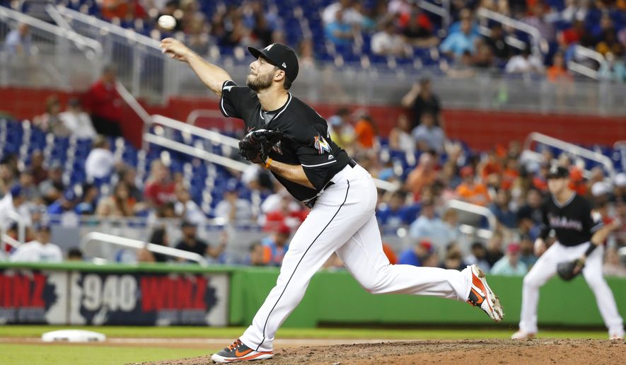 FILE - In this Sept. 21, 2018, file photo, Miami Marlins&#x27; Kyle Barraclough delivers a pitch during the 10th inning of a baseball game against the Cincinnati Reds, in Miami. The Washington Nationals picked up righty reliever Kyle Barraclough from Miami in their first offseason move to rebuild the bullpen. The Nationals said Wednesday, Oct. 10, 2018, that they gave the Marlins international slot value in the deal. (AP Photo/Wilfredo Lee, File)