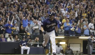 Milwaukee Brewers&#39; Mike Moustakas reacts after hitting an RBI single during the eighth inning of Game 2 of the National League Divisional Series baseball game against the Colorado Rockies Friday, Oct. 5, 2018, in Milwaukee. (AP Photo/Morry Gash)