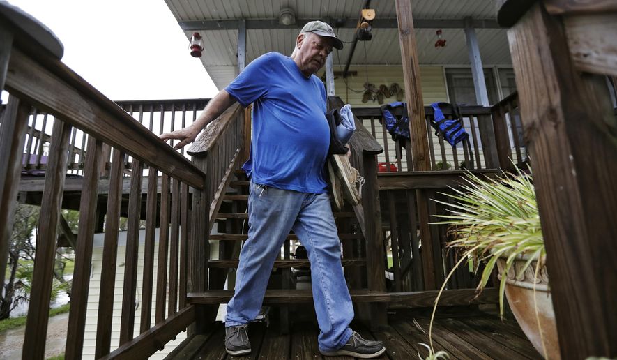 Cornell Silveira, of Keaton Beach, Fla., leaves with some of his belongings as he evacuates his home as Hurricane Michael approaches the area Wednesday, Oct. 10, 2018. Hurricane Michael continues to churn in the Gulf of Mexico heading for the Florida panhandle. (AP Photo/Chris O'Meara)