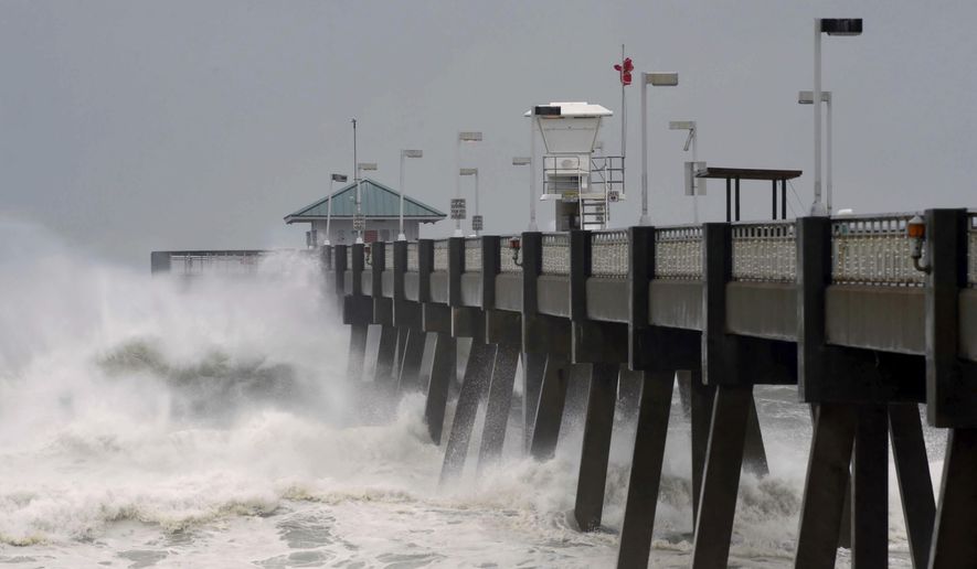 Heavy surf from the approaching Hurricane Michael pounds the fishing pier on Okaloosa Island in Fort Walton Beach, Fla., on Wednesday, Oct. 10, 2018. (Devon Ravine/Northwest Florida Daily News via AP)