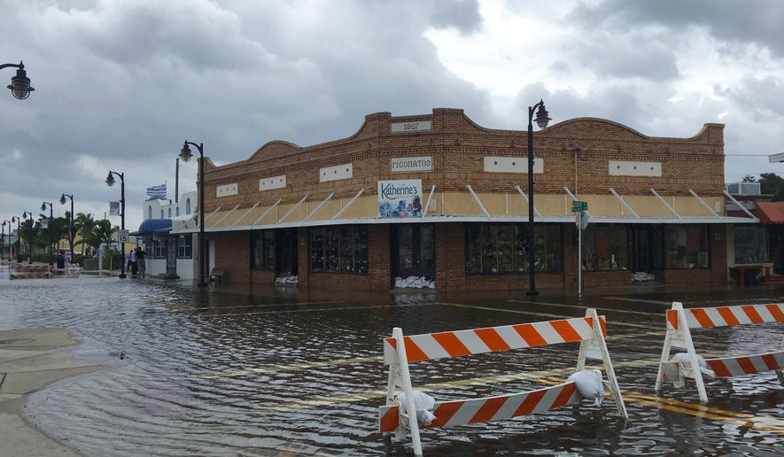 High tide from offshore Hurricane Michael creeps up into the Sponge Docks in Tarpon Springs, Fla., Wednesday, Oct. 10, 2018 after the Anclote River backs up. (Jim Damaske/The Tampa Bay Times via AP)