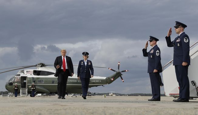 President Donald Trump boards Air Force One for a campaign rally in Erie, Pa., Wednesday, Oct. 10, 2018, in Andrews Air Force Base, Md. (AP Photo/Evan Vucci)