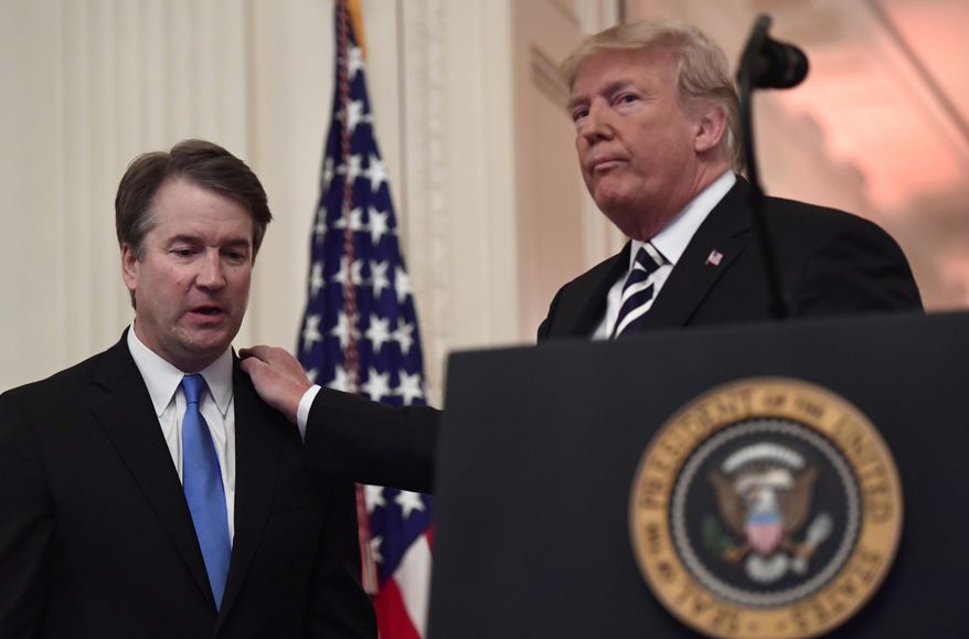President Donald Trump, right, stands with Supreme Court Justice Brett Kavanaugh, left, before a ceremonial swearing in in the East Room of the White House in Washington, Monday, Oct. 8, 2018. (AP Photo/Susan Walsh)