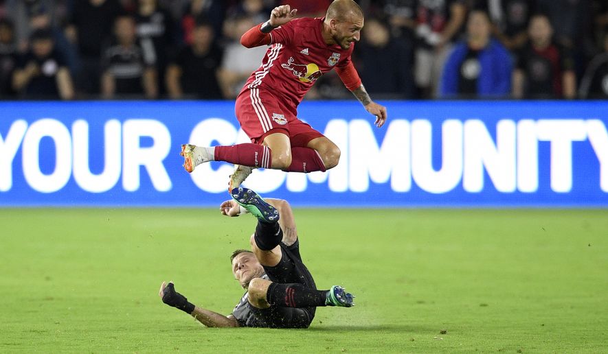 New York Red Bulls midfielder Daniel Royer, top leaps over D.C. United defender Frederic Brillant, bottom, during the second half of an MLS soccer match, Wednesday, July 25, 2018, in Washington. The Red Bulls won 1-0. (AP Photo/Nick Wass) **FILE**

