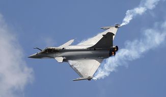 FILE - In this June 19, 2015 file photo, French Capt. Benoit Planche performs with a Rafale single seat jet aircraft during its demonstration flight at the Paris Air Show, in Le Bourget airport, north of Paris. India&#39;s defense minister is travelling Thursday Oct. 11, 2018 to Paris amid controversy over a multi-billion dollar deal in which France will sell 36 fighter jets to India. (AP Photo/Francois Mori,File)