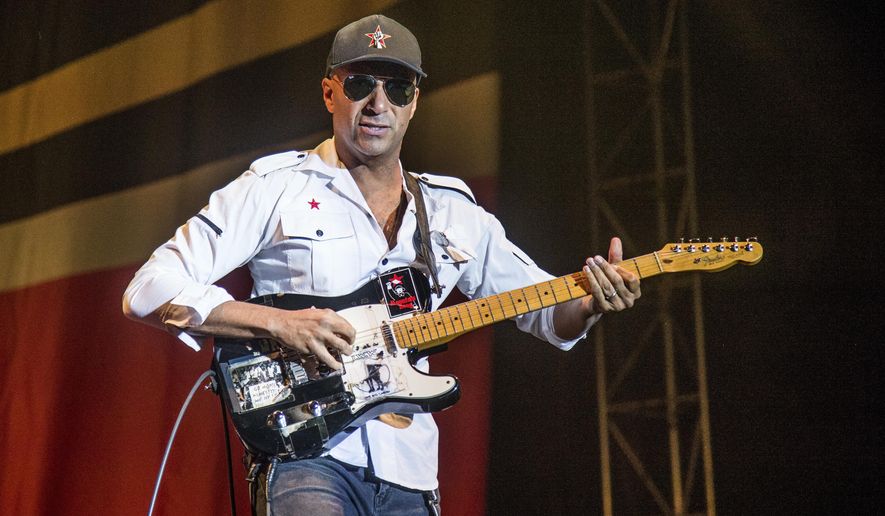 FILE - In this Oct. 1, 2017 file photo, Tom Morello, of Prophets of Rage, performs at the Louder Than Life Music Festival in Louisville, Ky. Morello released his latest album, &amp;quot;The Atlas Underground,&amp;quot; on Friday. (Photo by Amy Harris/Invision/AP, File)
