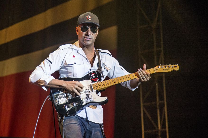 FILE - In this Oct. 1, 2017 file photo, Tom Morello, of Prophets of Rage, performs at the Louder Than Life Music Festival in Louisville, Ky. Morello released his latest album, &amp;quot;The Atlas Underground,&amp;quot; on Friday. (Photo by Amy Harris/Invision/AP, File)