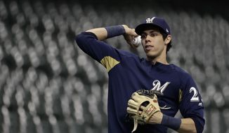 Milwaukee Brewers&#39; Christian Yelich warms up for practice for Game 1 of the National League Championship Series baseball game Los Angeles Dodgers Thursday, Oct. 11, 2018, in Milwaukee. (AP Photo/Matt Slocum)