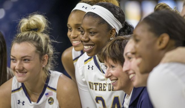 Notre Dame players and coaches pose for a group photo during the university's NCAA college basketball media day, Thursday, Oct. 11, 2018, in South Bend, Ind. (Robert Franklin/South Bend Tribune via AP)