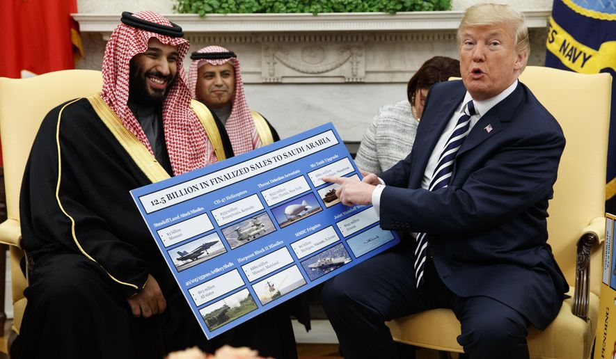 In this Tuesday, March 20, 2018 file photo, President Donald Trump holds a chart highlighting arms sales to Saudi Arabia during a meeting with Saudi Crown Prince Mohammed bin Salman in the Oval Office of the White House in Washington. (AP Photo/Evan Vucci) **FILE**