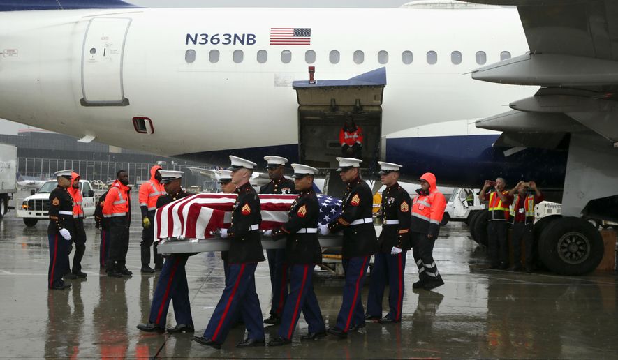 A United States Marine Corps honor guard carries the casket of USMC Technical Sergeant Harry Carlsen as it arrives aboard a Delta flight at Chicago O'Hare International Airport on Wednesday, Oct. 10, 2018 in Chicago. His family as well as Chicago police and fire personnel turned out to honor him. He served in the USMC during WWII as the Quartermaster Maintenance Chief for Company A of the 2nd Marine Divisions' 2nd Amphibious Tractor Battalion. He was killed in action on Nov. 20, 1943 in Betio Island Red Beach One, Tarawa Atoll, Gilbert Islands but his remains were just identified this year. (Stacey Wescott/Chicago Tribune via AP)