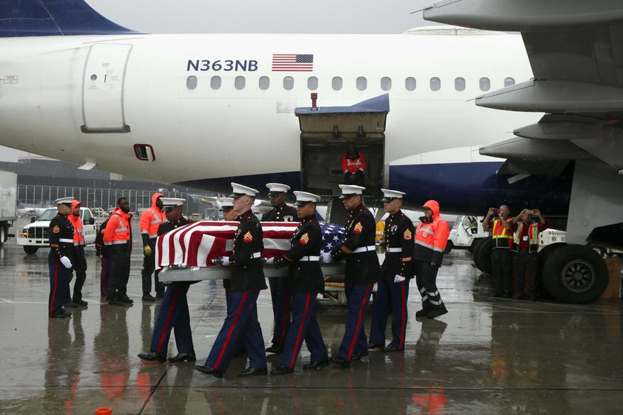 A United States Marine Corps honor guard carries the casket of USMC Technical Sergeant Harry Carlsen as it arrives aboard a Delta flight at Chicago O'Hare International Airport on Wednesday, Oct. 10, 2018 in Chicago. His family as well as Chicago police and fire personnel turned out to honor him. He served in the USMC during WWII as the Quartermaster Maintenance Chief for Company A of the 2nd Marine Divisions' 2nd Amphibious Tractor Battalion. He was killed in action on Nov. 20, 1943 in Betio Island Red Beach One, Tarawa Atoll, Gilbert Islands but his remains were just identified this year. (Stacey Wescott/Chicago Tribune via AP)
