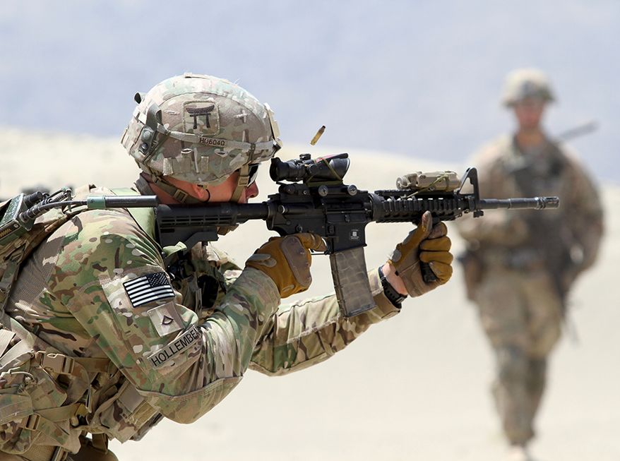 In this file photo, a 101st Airborne Division infantryman fires an M4 carbine during partnered live-fire range training May 29, 2015 in eastern Afghanistan. On Feb. 12, 2020, the Army announced it is cycling out a brigade from the storied 101st from a deployment in Africa, replacing it with a new Army unit set up specifically to train and advise foreign military units and called the 1st Security Force Assistance Brigade. (U.S. Army photo by Capt. Charlie Emmons, TAAC-E Public Affairs) **FILE**