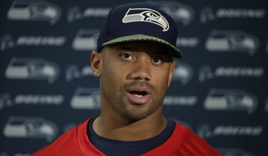 Seattle Seahawks quarterback Russell Wilson speaks during a press conference after an NFL training session at the Grove Hotel in Chandler&#39;s Cross, Watford, England, Friday, Oct. 12, 2018. The Seattle Seahawks are preparing for an NFL regular season game against the Oakland Raiders in London on Sunday. (AP Photo/Matt Dunham)