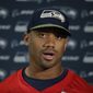 Seattle Seahawks quarterback Russell Wilson speaks during a press conference after an NFL training session at the Grove Hotel in Chandler&#x27;s Cross, Watford, England, Friday, Oct. 12, 2018. The Seattle Seahawks are preparing for an NFL regular season game against the Oakland Raiders in London on Sunday. (AP Photo/Matt Dunham)