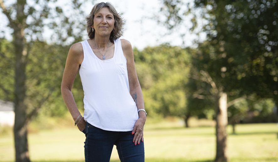 In this Oct. 2, 2018 photo, Denise Valley poses in Millsboro, Del., Valley is living with Stage IV breast cancer. When she was first diagnosed, at stage II, she was super involved in fundraisers and walks, but her stage IV diagnosis made her see October in a different light. (Jason Minto /The News Journal via AP)