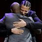 Former NFL quarterback Colin Kaepernick, right, hugs comedian Dave Chappelle, left, on stage during W.E.B. Du Bois Medal award ceremonies, Thursday, Oct. 11, 2018, at Harvard University, in Cambridge, Mass. Kaepernick and Chappelle are among eight recipients of Harvard University&#39;s W.E.B. Du Bois Medals in 2018. Harvard has awarded the medal since 2000 to people whose work has contributed to African and African-American culture. (AP Photo/Steven Senne)