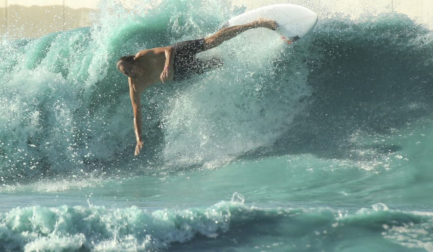 FILE - In this July 14 2018, file photo, a surfer takes a spill while battling the waves at the BSR Surf resort near Waco, Texas. Health officials say a New Jersey man who died from a rare "brain-eating amoeba" was likely exposed to it during his visit to the Texas water resort last month. The Waco-McLennan County Public Health District said Friday, Oct. 12, 2018, that testing done by the Centers for Disease Control and Prevention found evidence of the amoeba at one of the four attractions at the BSR Cable Park and Surf Resort in Waco. (Rod Aydelotte/Waco Tribune Herald, via AP File)