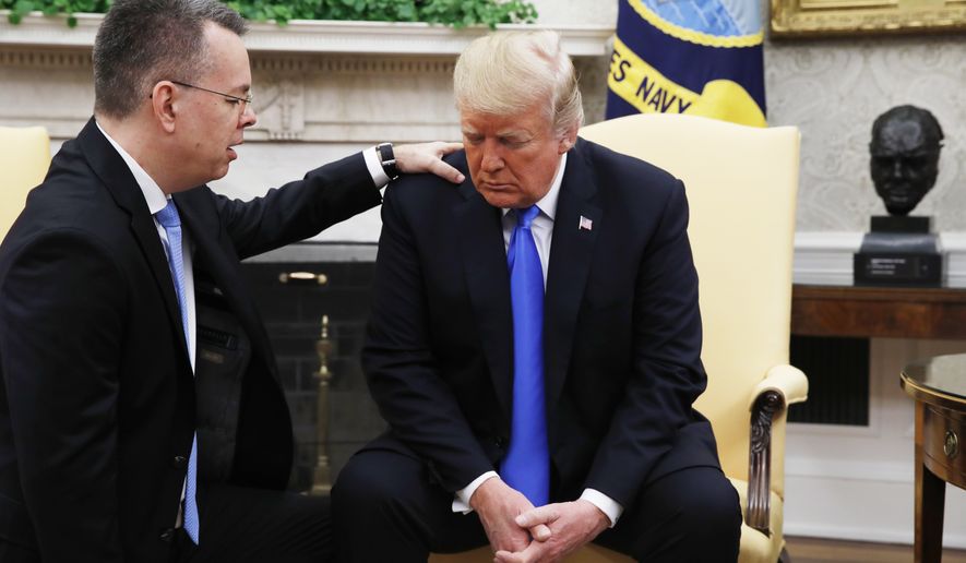 President Donald Trump prays with American pastor Andrew Brunson in the Oval Office of the White House, Saturday October 13, 2018, in Washington. Brunson returned to the U.S. around midday after he was freed Friday, from nearly two years of detention in Turkey. (AP Photo/Jacquelyn Martin)