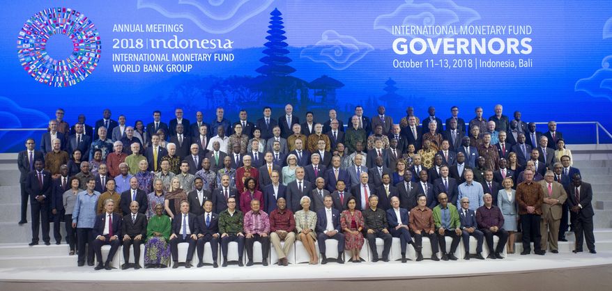 International Monetary Fund (IMF) governors gather for a group photo during the IMF and World Bank meetings in Bali, Indonesia on Saturday, Oct. 13, 2018. (AP Photo/Firdia Lisnawati)
