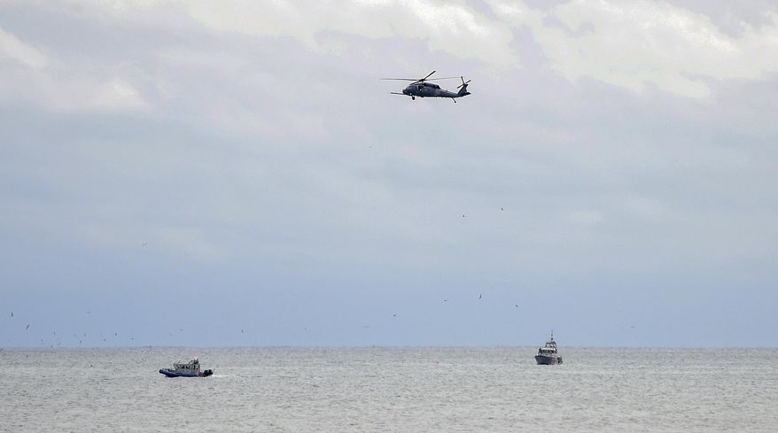 Rescue personnel search for a plane that crashed into the waters off Quogue on New York's Long Island Saturday, Oct. 13, 2018. Authorities on Long Island say a small private plane carrying three people crashed into the ocean Saturday several miles off the Hamptons. (James Carbone/Newsday via AP)