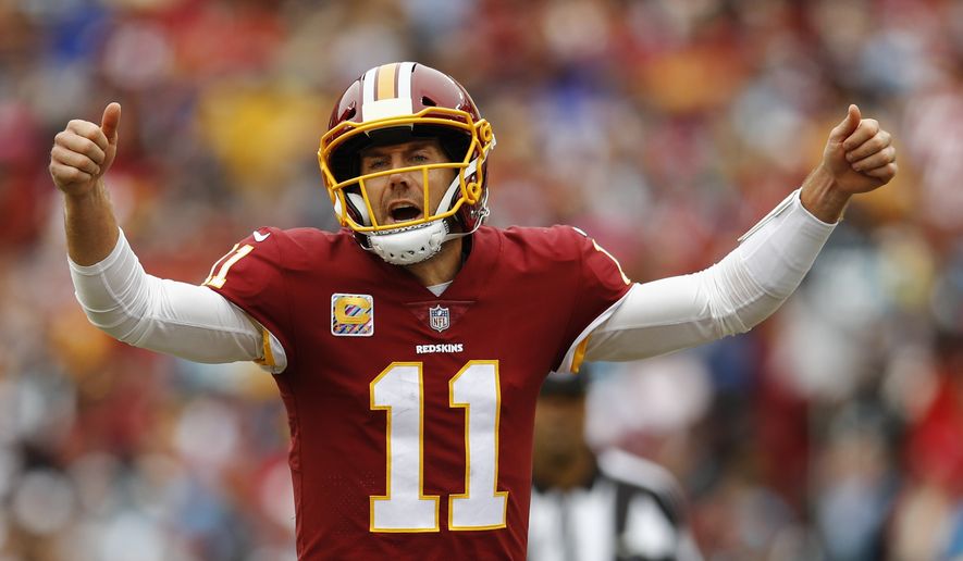 Washington Redskins quarterback Alex Smith (11) signals the line during the first half of an NFL football game between the Washington Redskins and the Carolina Panthers, Sunday, Oct. 14, 2018 in Landover, Md. (AP Photo/Patrick Semansky)