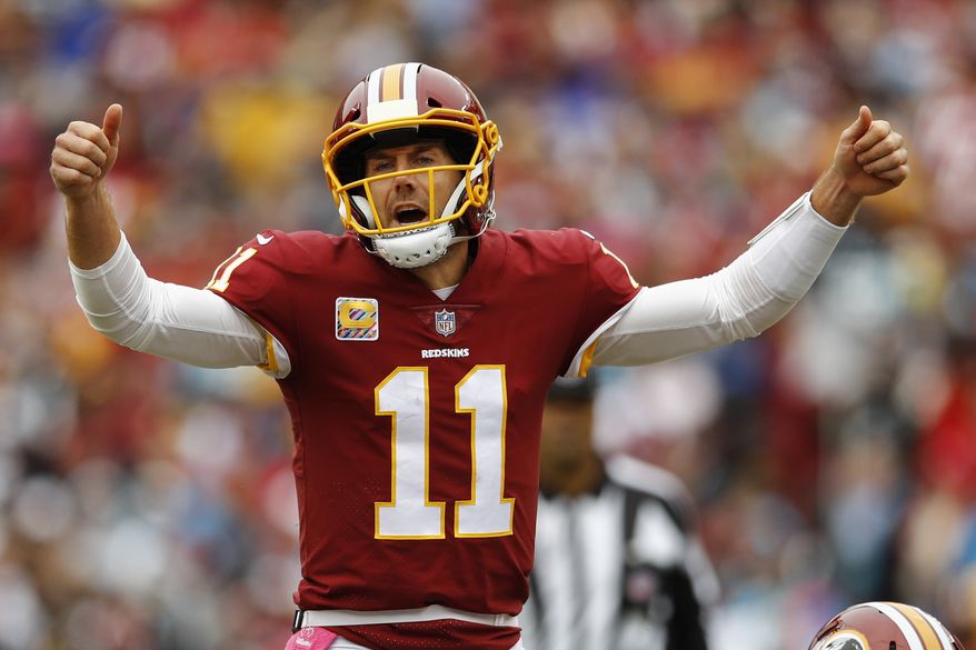 Washington Redskins quarterback Alex Smith (11) signals the line during the first half of an NFL football game between the Washington Redskins and the Carolina Panthers, Sunday, Oct. 14, 2018 in Landover, Md. (AP Photo/Patrick Semansky)