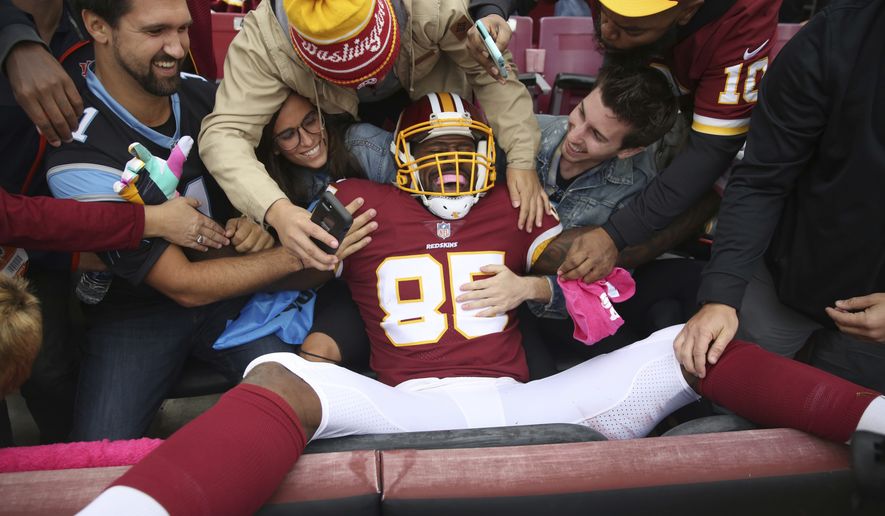 Washington Redskins tight end Vernon Davis (85) celebrates with fans after this touchdown catch during the first half of an NFL football game against the Carolina Panthers, Sunday, Oct. 14, 2018, in Landover, Md. (AP Photo/Pablo Martinez Monsivais)