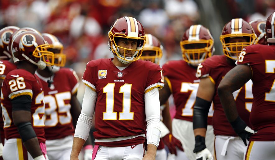 Washington Redskins quarterback Alex Smith waits to huddle with teammates during an NFL football game against the Carolina Panthers, Sunday, Oct. 14, 2018 in Landover, Md. (AP Photo/Patrick Semansky) **FILE**