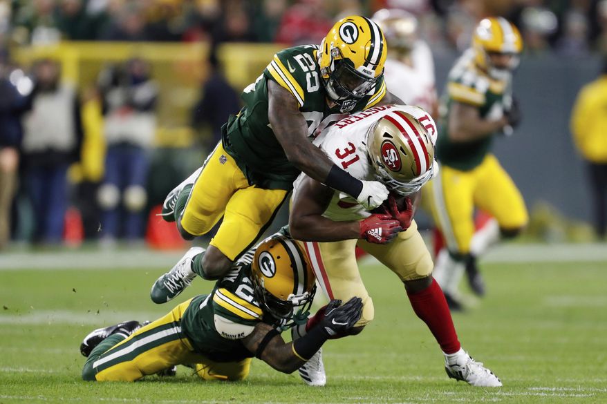 San Francisco 49ers running back Raheem Mostert (31) is tackled by Green Bay Packers free safety Ha Ha Clinton-Dix (21) and strong safety Kentrell Brice (29) during the first half of an NFL football game Monday, Oct. 15, 2018, in Green Bay, Wis. (AP Photo/Matt Ludtke)
