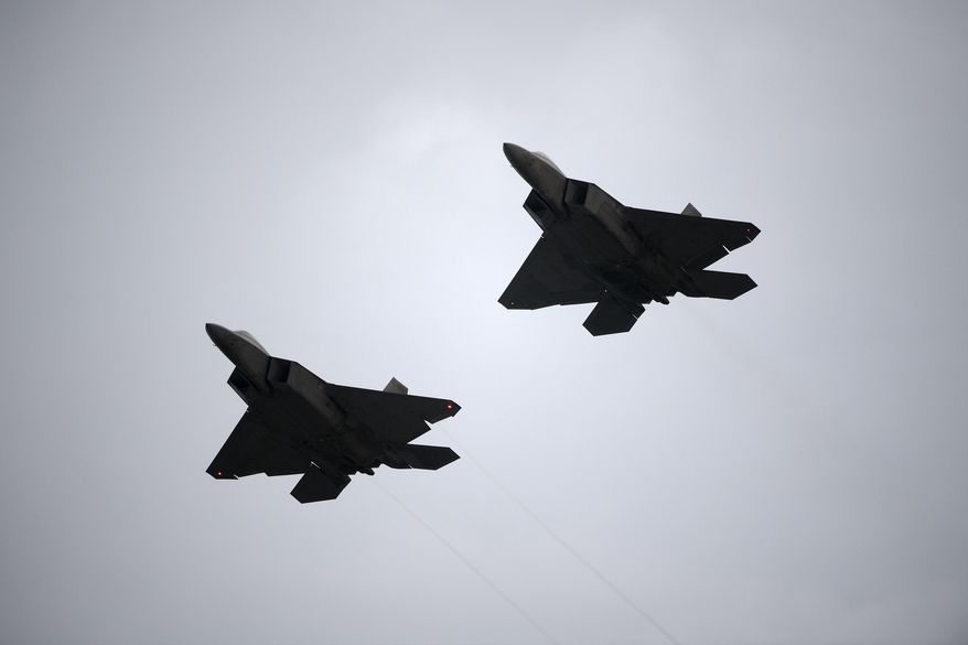 Two U.S. Air Force F-22 fighter jets perform a flyover during the playing of the national anthem before a NASCAR Cup Series auto race at Daytona International Speedway, Saturday, July 7, 2018, in Daytona Beach, Fla. (AP Photo/Phelan M. Ebenhack) ** FILE **