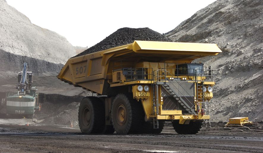 In this April 4, 2013, file photo, a mining dumper truck hauls coal at Cloud Peak Energy&#39;s Spring Creek strip mine near Decker, Mont. The Trump administration is considering using West Coast military bases or other federal properties as transit points for shipments of U.S. coal and natural gas to Asia. (AP Photo/Matthew Brown, File)