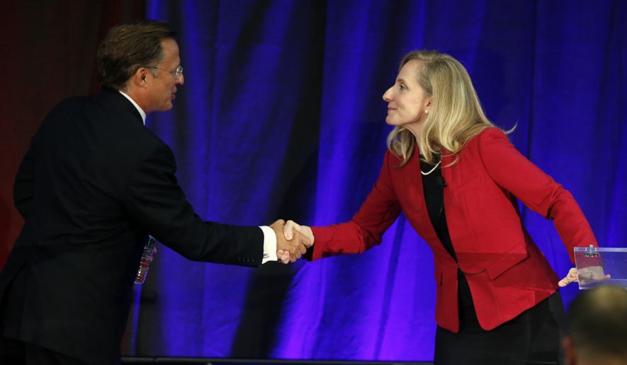 Virginia Congressman Dave Brat, R-Va., left, shakes hands with Democratic challenger Abigail Spanberger, right, after a debate at Germanna Community College in Culpeper, Va., Monday, Oct. 15, 2018. (AP Photo/Steve Helber) ** FILE **